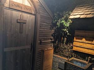 A small wooden church beside a well.