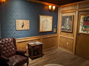 Wide view of a study with a large leather chair and a key maze.