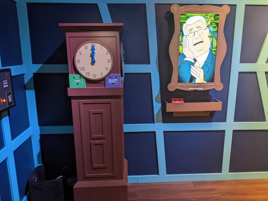A grandfather clock beside a strange portrait.