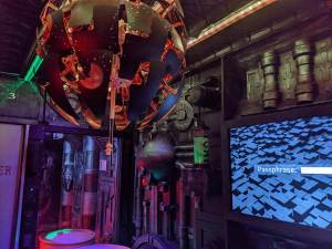 An unusual object hanging from the ceiling in a futuristic setting.