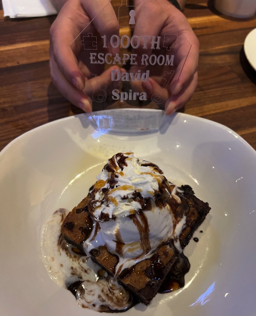 A laser cut acrylic 1,000 game trophy over a brookie with ice cream.