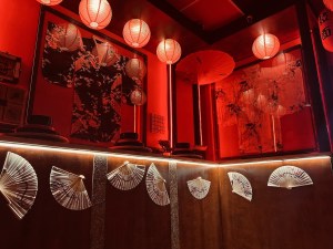 A series of red paper lanterns and white fans hung on the wall.