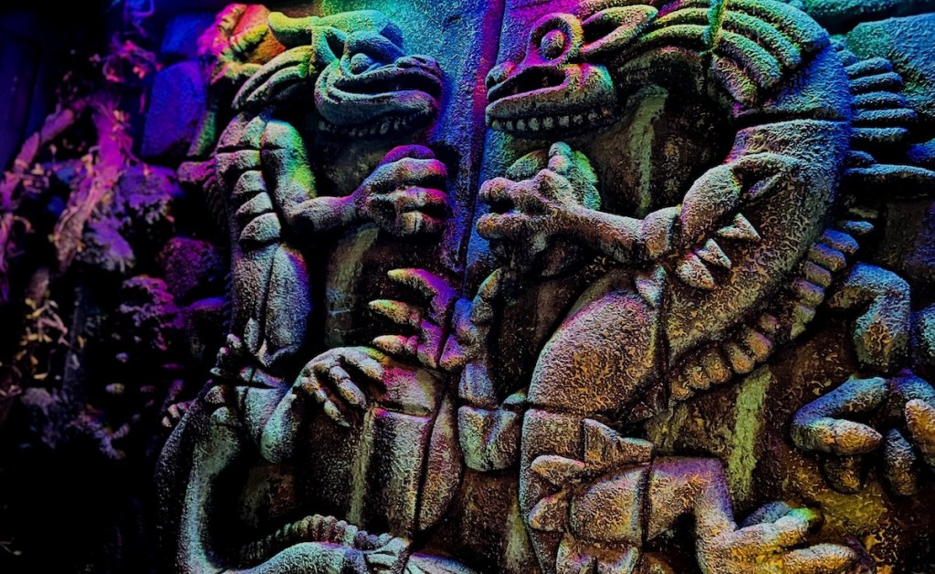 Two carved stone Kami dragons looking at one another.