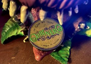 An "Oddinero" coin in the mouth of the flytrap puppet.