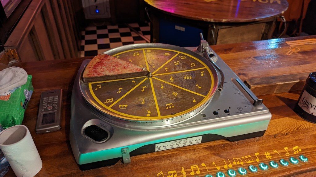 A turntable with a slice of pizza on it.