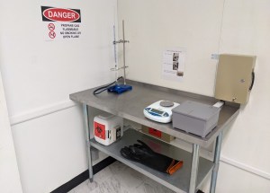 Closeup of a steel table with science equipment.