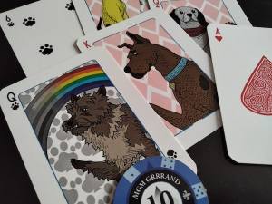 A close-up of some playing cards with illustrated dogs as the face cards