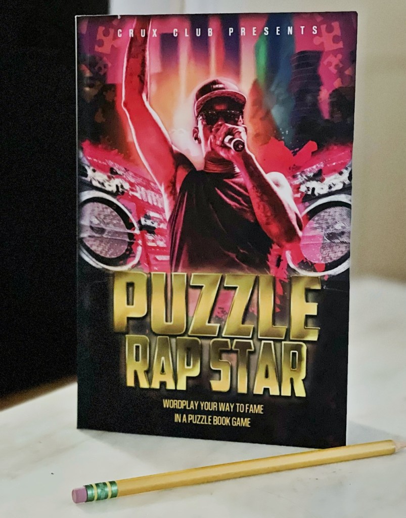 Puzzle Rap Star book cover depicts a rapper holding a mic in one hand, with his other hand in the air.