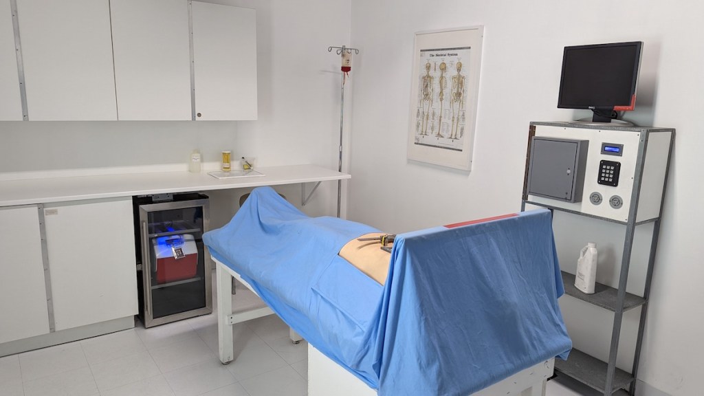 A hospital room with a beg and imaging equipment.