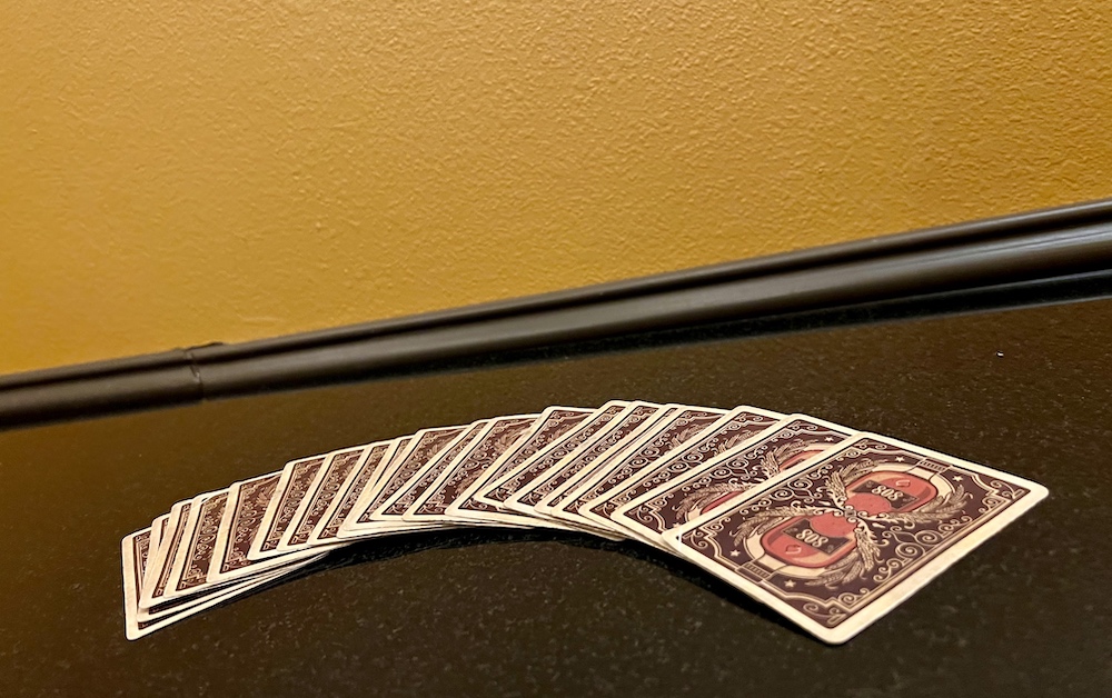 A deck of cards fanned out on a table.