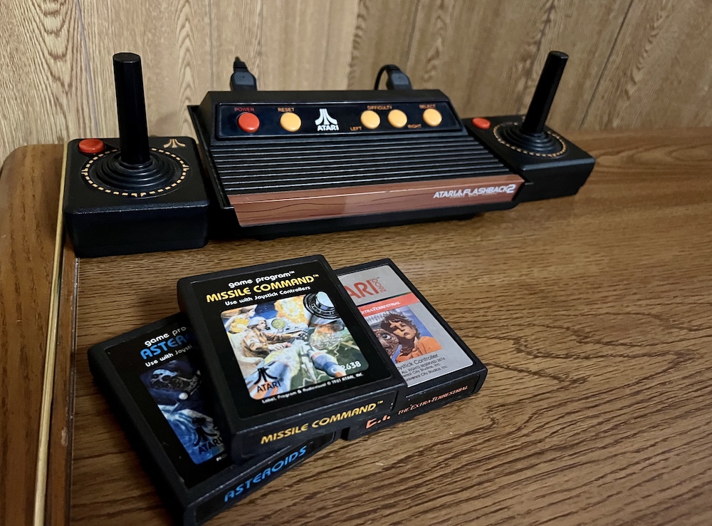 Closeup of an Atari and 3 cartridges.