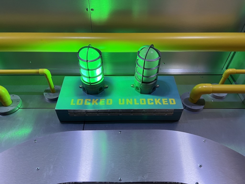 Glowing green locked indicator beside an unlit unlocked indicator.