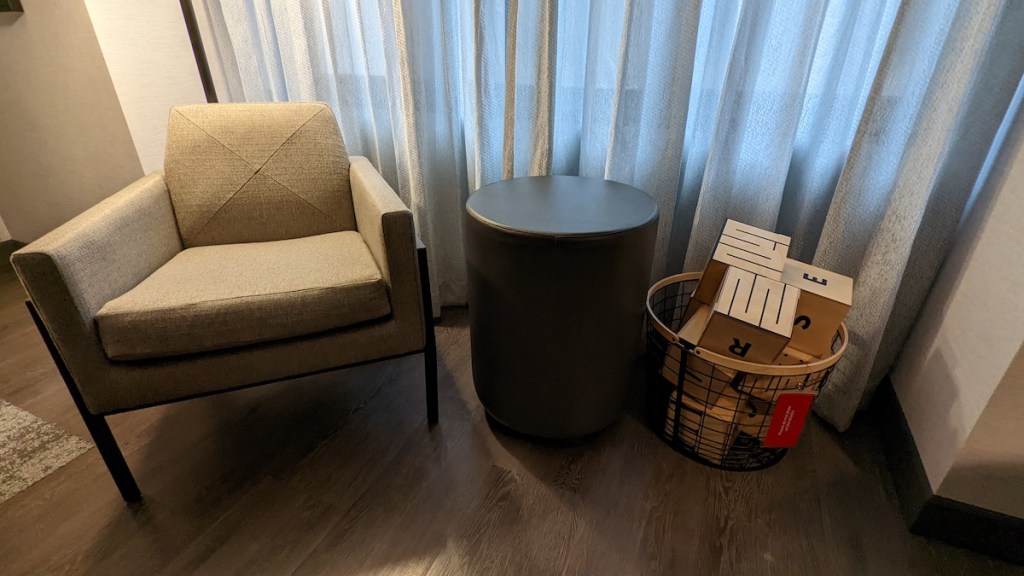 A chair, a table, and a basket with large puzzle blocks.