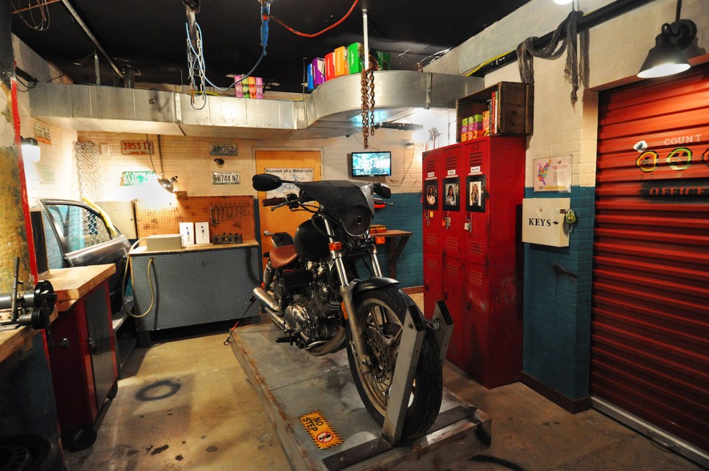 A body shop interior with a motorcycle being worked on.