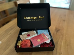 Black scavenger Box open on a table with its components inside.