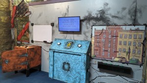 A computer with a strange interface in a damaged room.