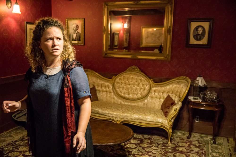 A performer looking concerned in a beautiful parlour.