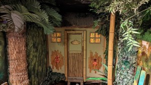 Exterior of a small tiki bar on a tropical island.