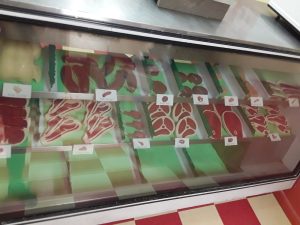 Closeup of a deli's meat counter.