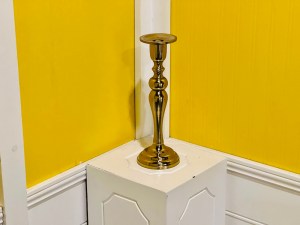 A candlestick on a pedestal.