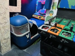 A ride car beside a carnival game.