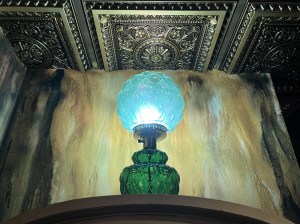 A glowing, green, antique light in an old room.