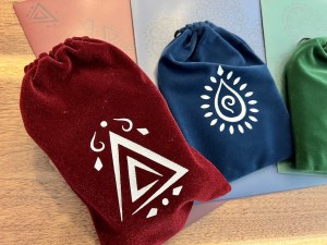 Closeup of 3 colored (red, blue, green) cloth bags on matching folders.