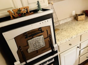 An antique oven decorated for Christmas.