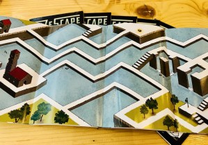 A maze unfolded on a table.