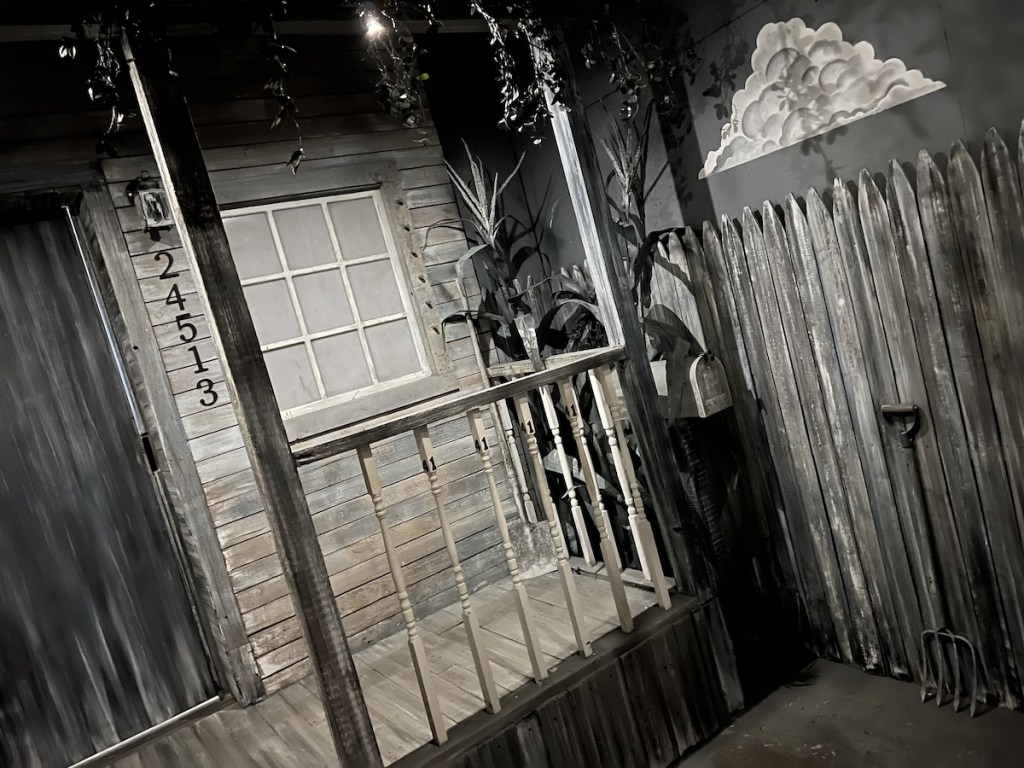 A black & white front porch of an old farmhouse.