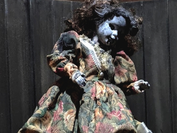 A very creepy doll covered in soot.