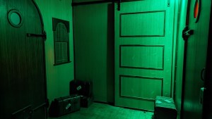 A room in a train lit an eerie green.