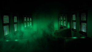 An old passenger train interior lit an eerie green.