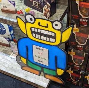 Alien cardboard standee whose shirt reads, "BRISKET LOX COLESLAW TRIPE"