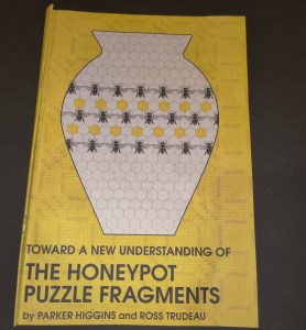 Booklet cover: A vase covered in hexagons and bees. Title reads, "Towards A New Understanding of the Honeypot Puzzle Fragments by Parker Higgins and Ross Trudeau."