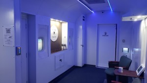 A seating cabin crew area in a stark white passenger plane.