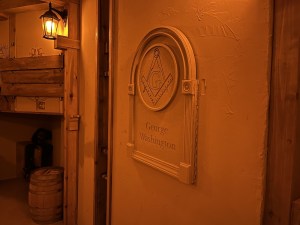 A stone carving of the Freemason's symbol with George Washington's name carved beneath it.