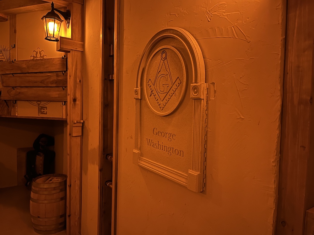 A stone carving of the Freemason's symbol with George Washington's name carved beneath it.