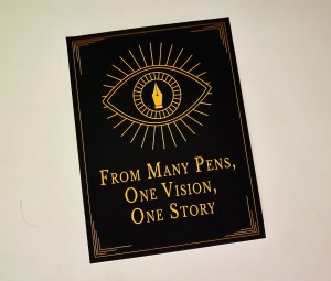 An art deco poster with a fountain pen nib in the middle of an eye. Text reads, "From many pens, one vision, one story."