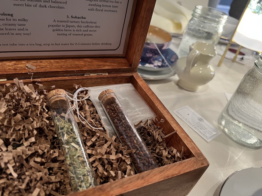 Closeup of an opened tea box with beautiful corked test tubes of looseleaf teas.