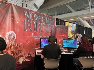 A pair of people demoing a PC co-op puzzle game named "We Were Here Forever."