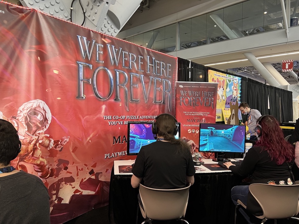 A pair of people demoing a PC co-op puzzle game named "We Were Here Forever."