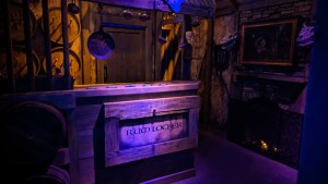 A kitchen onboard a ship. A large box is labeled "Rum Locker."