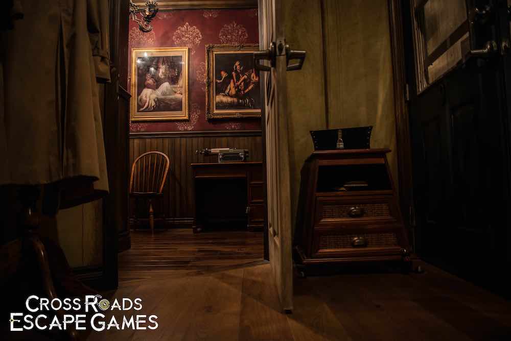 A view from a dingy room into an elegant room with art on the walls.