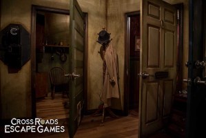 The detective's room. A trench coat and hat are hung from a coatrack.