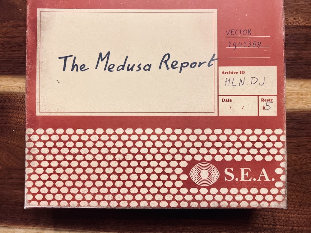 Box art for "The Medusa Report" looks like a box for a case-file produced by an espionage organization called, "S.E.A."