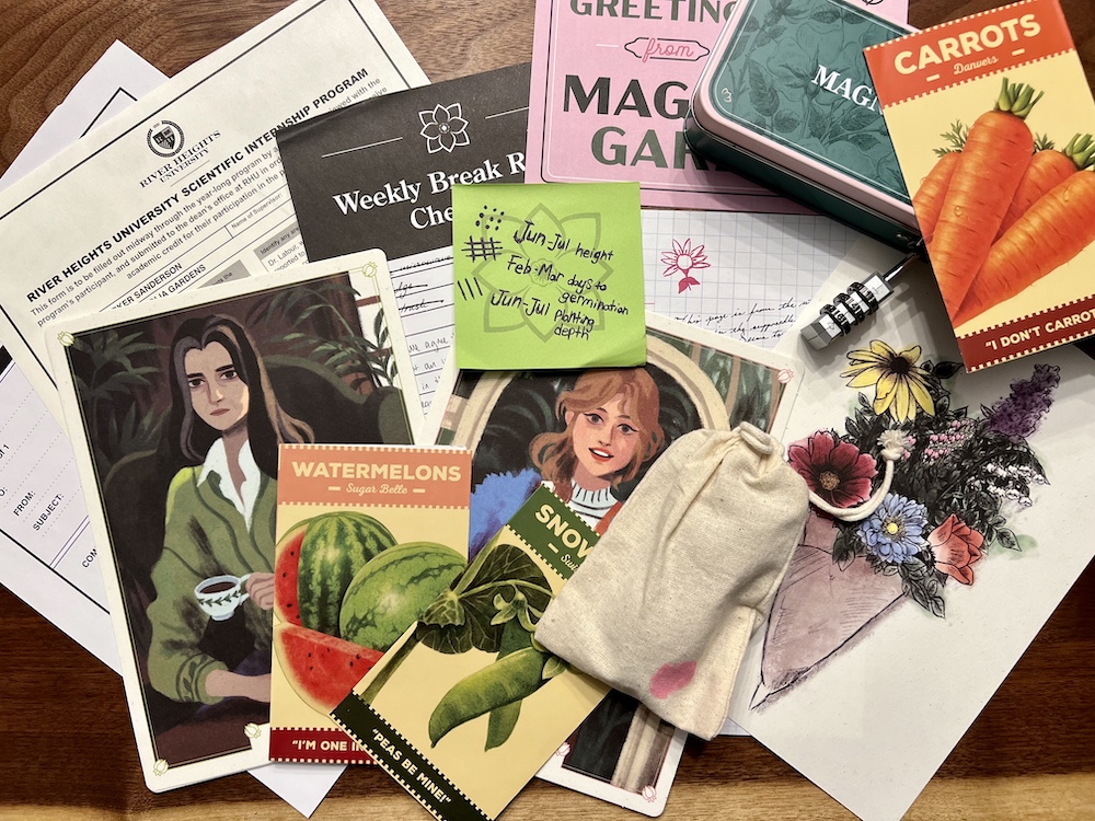 An assortment of paper items with illustrations along with a locked tin and a canvas bag with a pink stain.