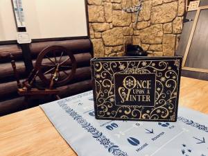 Book on the table, the title reads, "Once Upon a Winter"