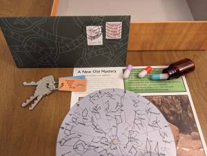 Puzzle components include a key ring with 3 oddly cut keys, a pill jar with 3 pills, and a star chart.