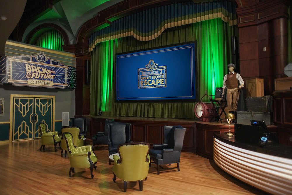 Universal's Great Movie Escape art deco lobby with a stage and large comfortable chairs.